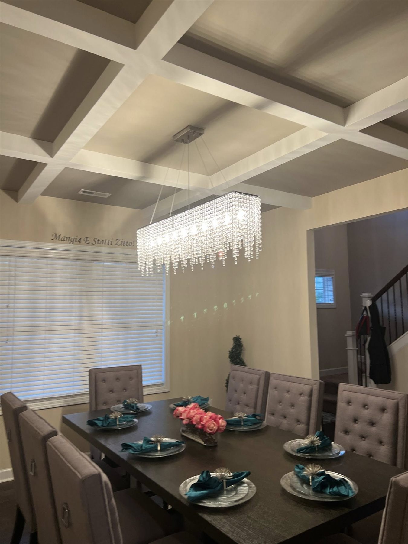 Dining room with custom coffered ceiling and crystal chandelier installed