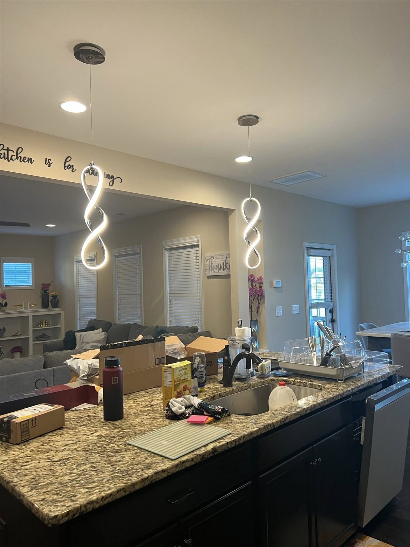 Kitchen with granite island and new spiral pendant lights over the sink
