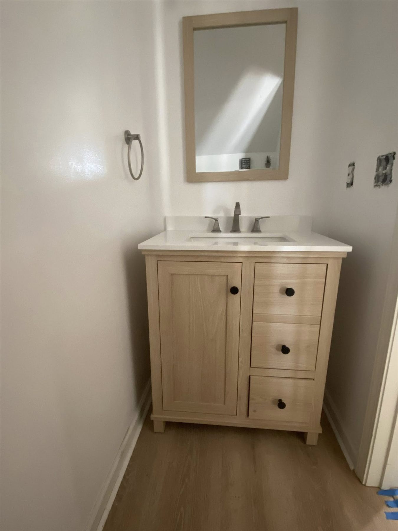 Guest bathroom with new white oak vanity, mirror, and fixtures